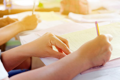 Close-up of women writing book