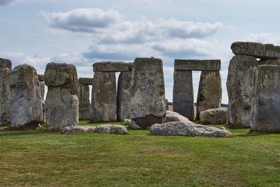 Neolithic stone circle on field against sky