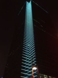 Low angle view of illuminated modern skyscraper