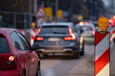 Evening traffic jam during road repairs, ntense traffic flow of in cars rush hours, rear viev