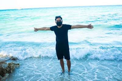 Full length of man standing on beach