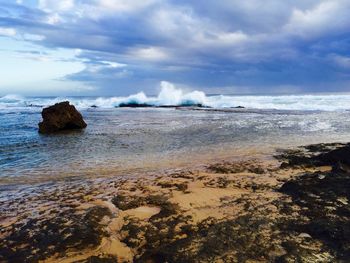 Scenic view of sea against cloudy sky