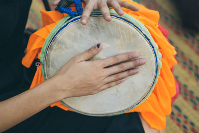 Midsection of man playing guitar