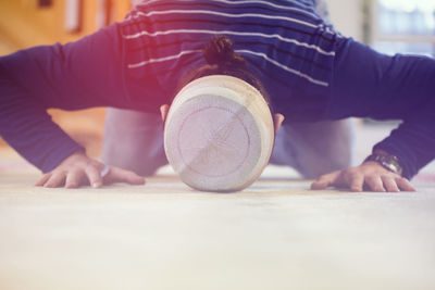 Midsection of woman lying on floor