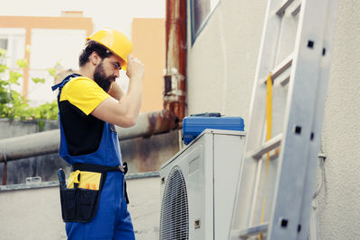 Side view of man working in factory