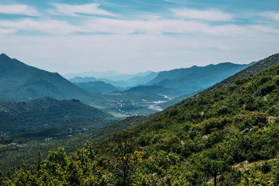 Scenic view of mountains against cloudy sky