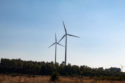 Windmill on field against sky