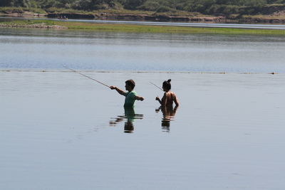 Men fishing in lake