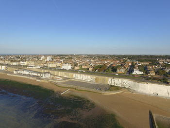 High angle view of buildings against clear blue sky