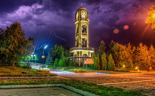 Illuminated building against sky at night
