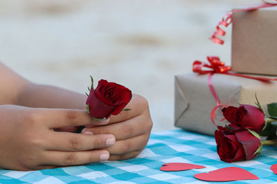 Close-up of red rose on table