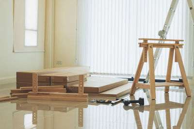 Empty chairs and table against wall at home