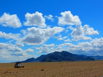Scenic view of landscape against cloudy sky