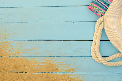 Directly above shot of rope tied on wooden table