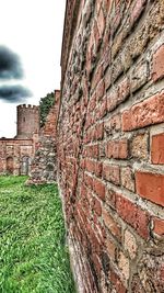 Stone wall of old ruin against sky