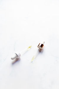 Retinol oil serum oil pipettes on isolated marble background