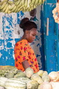 Beautiful african girl on the background of vegetables in the market. natural products.