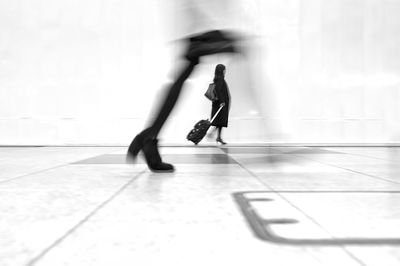 Low section of woman walking on tiled floor