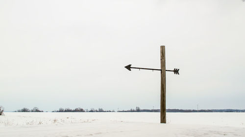 Scenic view of field against clear sky during winter