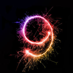 Number 9 made by multi colored sparklers at night