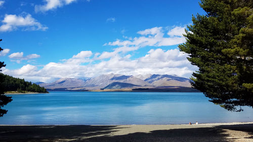 Scenic view of mountains against blue sky