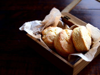 Close-up of lemon scones in wooden box on table