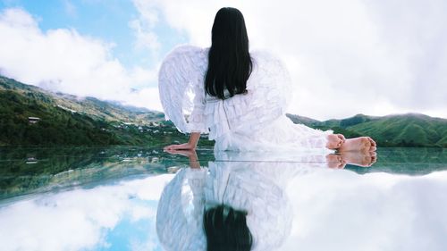 Rear view of woman standing in water