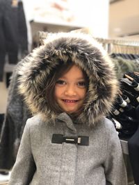 Portrait of smiling girl wearing jacket in winter