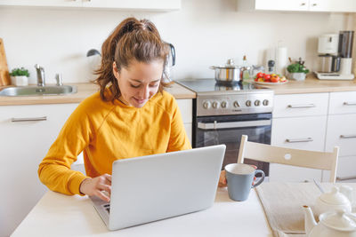 Boy using laptop at home