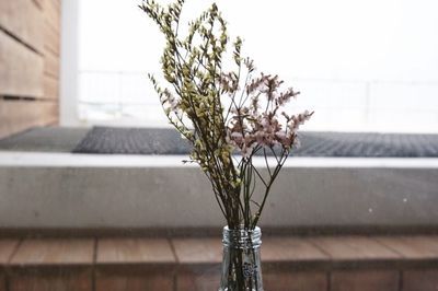 Close-up of flower vase on table at home