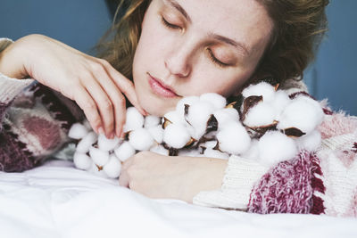 Portrait of young woman sitting on bed