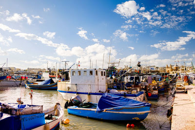 Boats moored at harbor in city