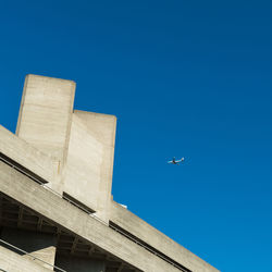 Low angle view of airplane flying in sky