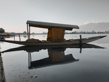 Built structure in lake against sky