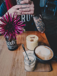 Woman holding coffee cup on table