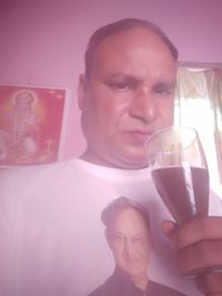 Portrait of smiling man holding drink
