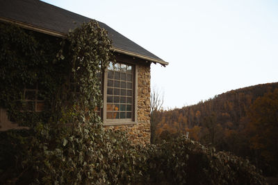 House by building against clear sky