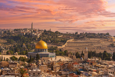 Sunset view of jerusalem dominated by golden cupola of the dome of the rock
