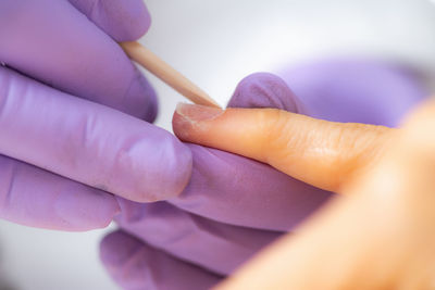 Close-up of woman hand holding finger