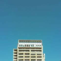 Low angle view of built structure against clear blue sky