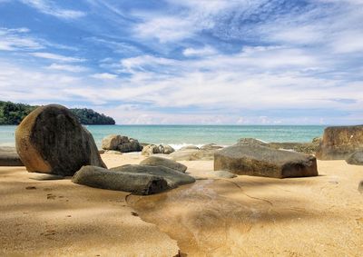 Rocks on beach against sky