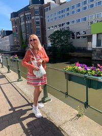 Full length of woman standing against building