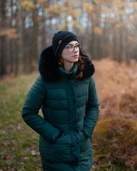 Portrait of young woman standing on field