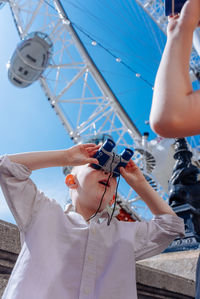 Side view of man photographing through binoculars