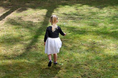 Full length of girl standing on grassy field