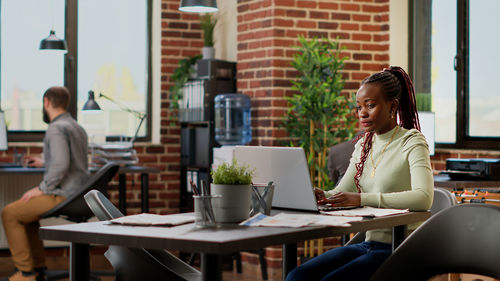 Young woman using laptop at table