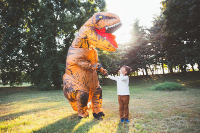 Full length of boy standing on field