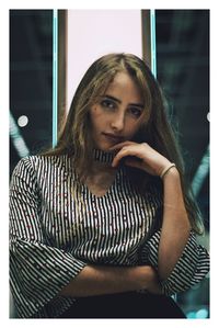 Portrait of young woman sitting outdoors