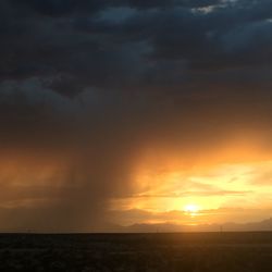 Scenic view of landscape against cloudy sky