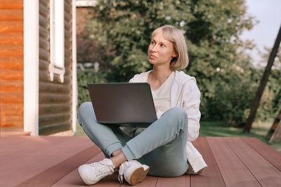 Young woman using laptop at home